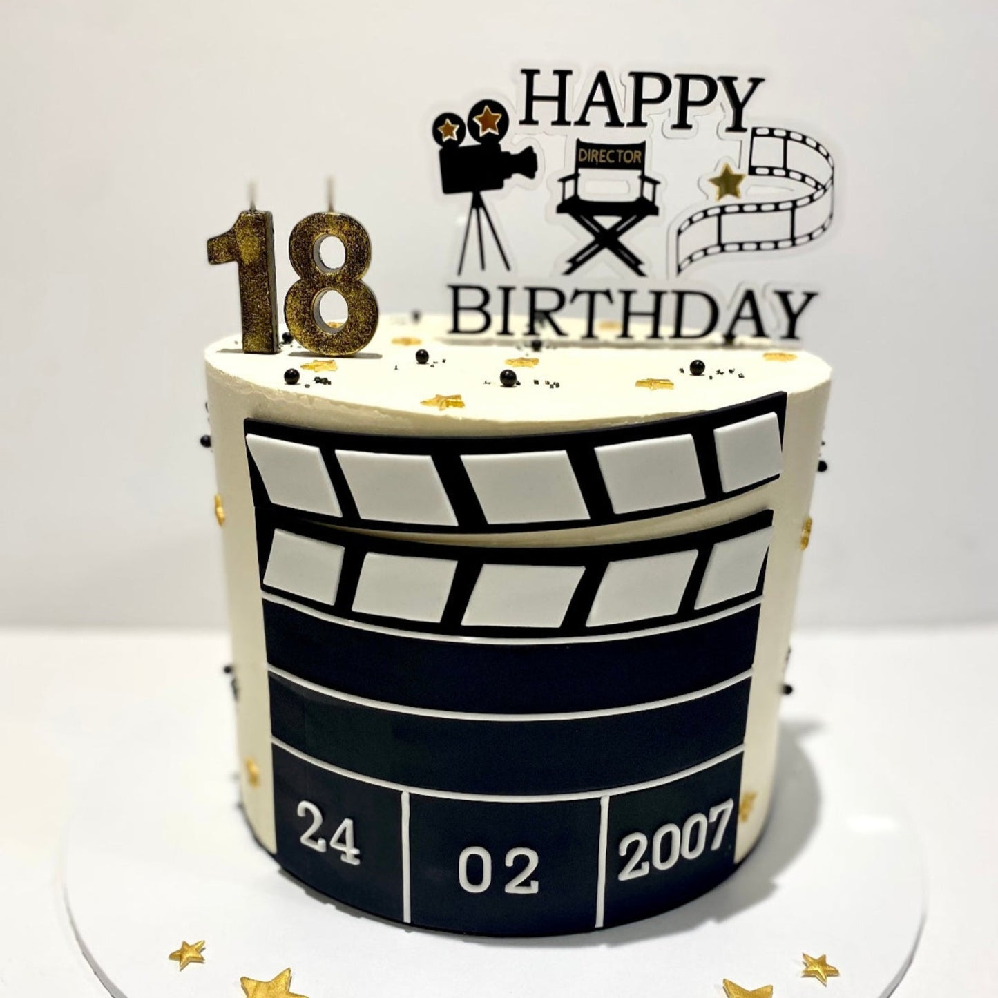 Birthday cake with 'Happy Birthday' text, and movie-themed cake topper.