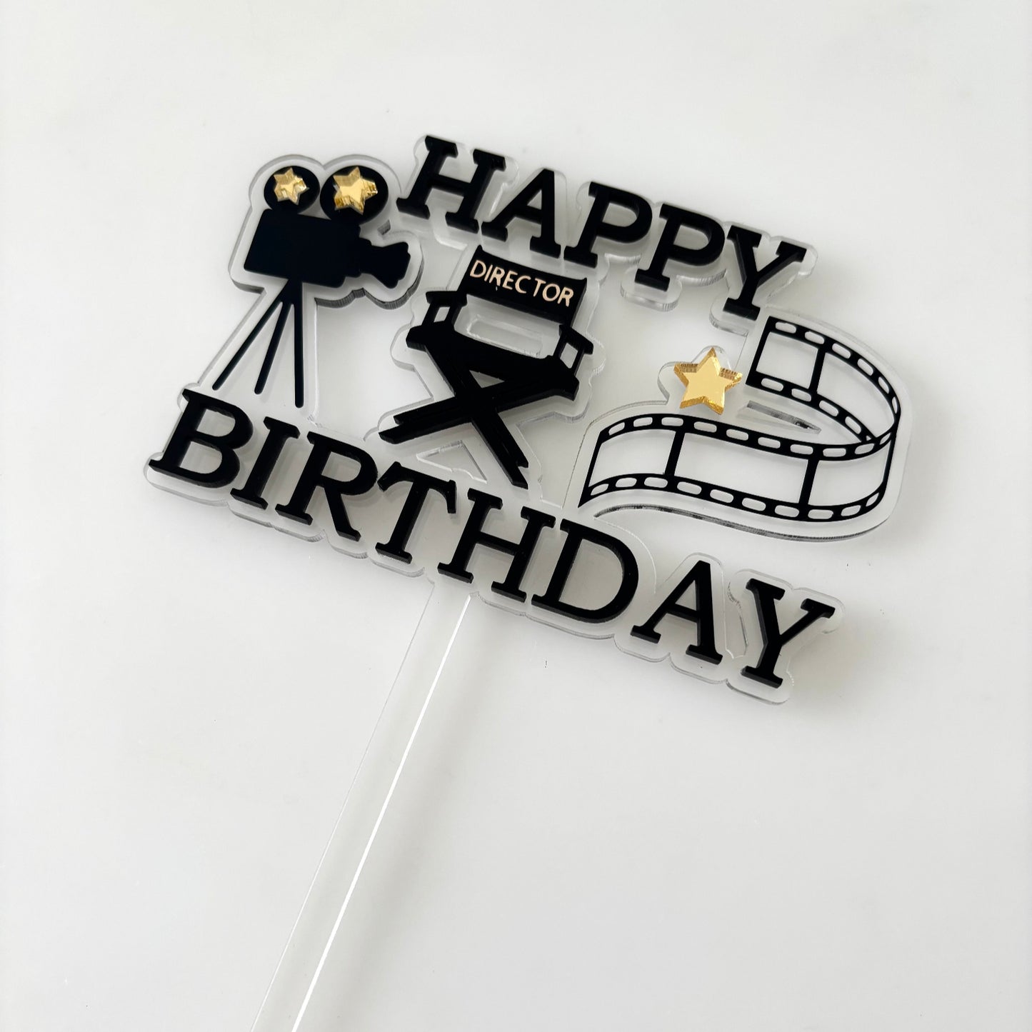 Cake topper with movie-themed design on a white background