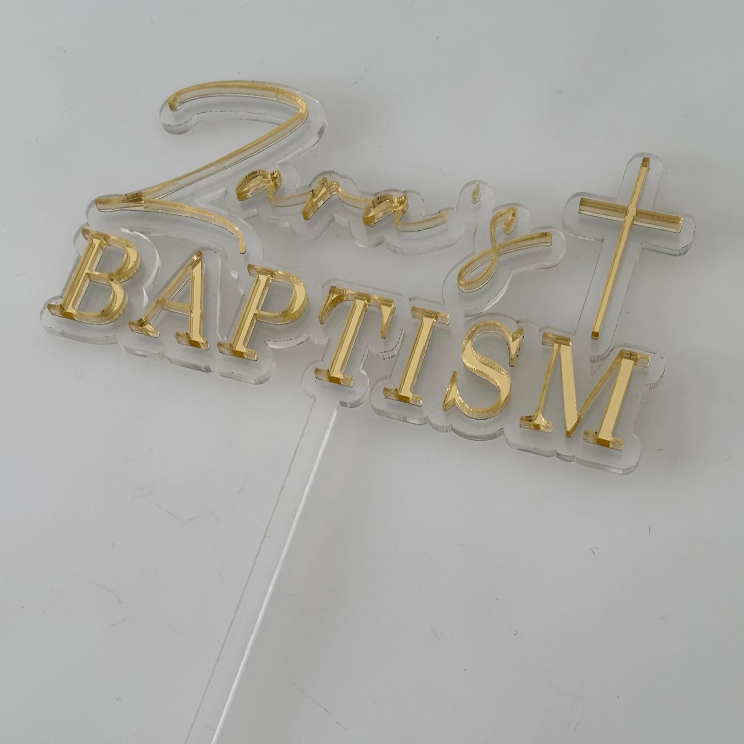 Gold Customised 'Baptism' cake topper on a white background