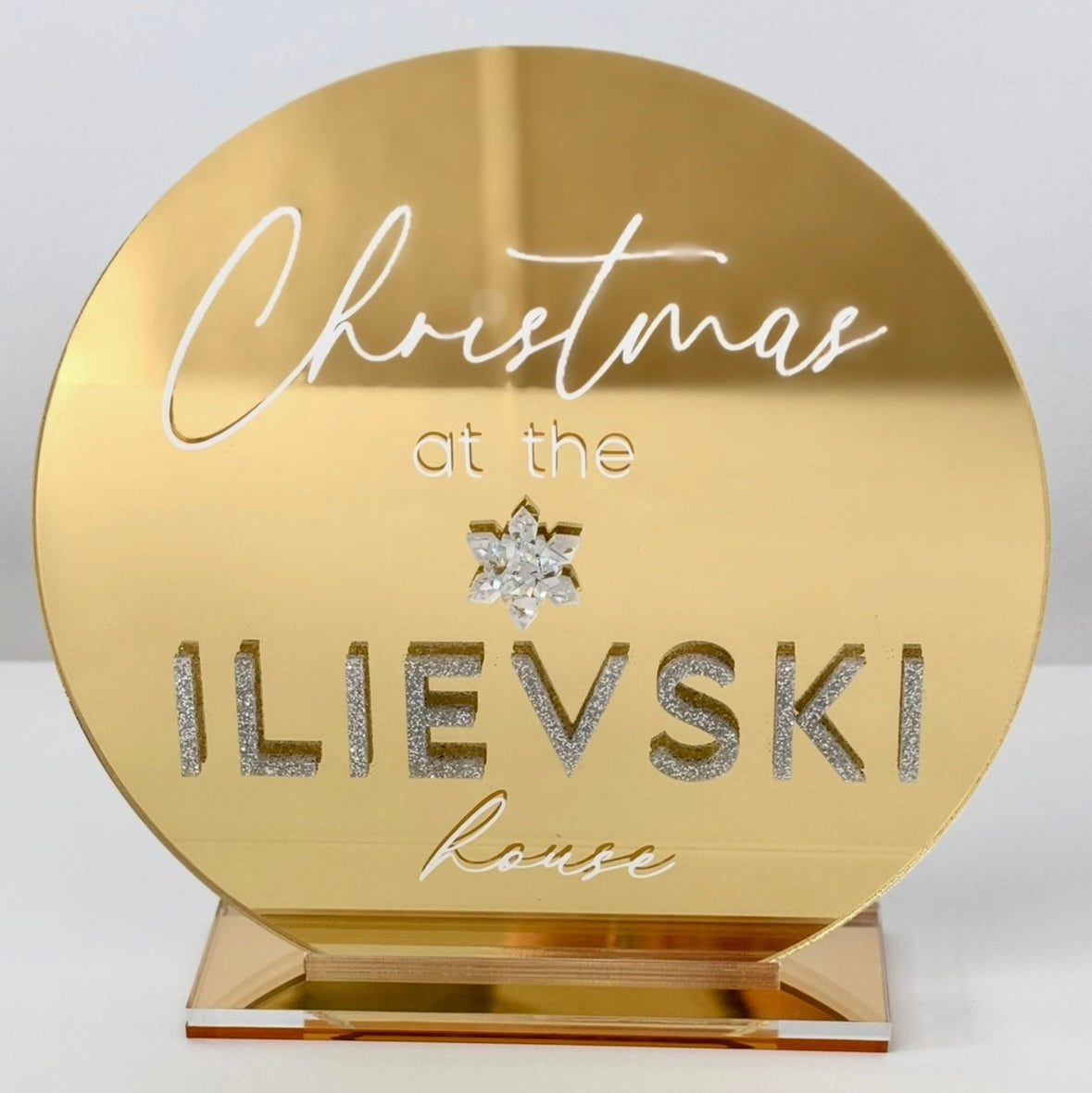 Gold plaque with 'Christmas at the ILIEVSKI house' text on a white background