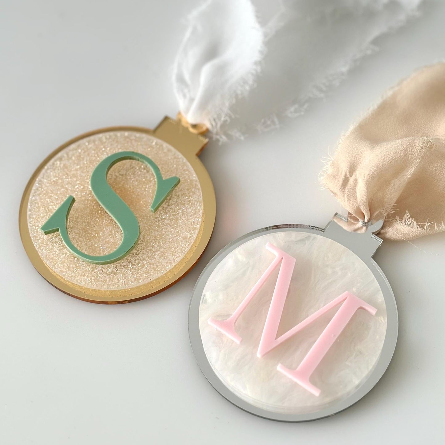 Christmas baubles with a 'M' on a light background