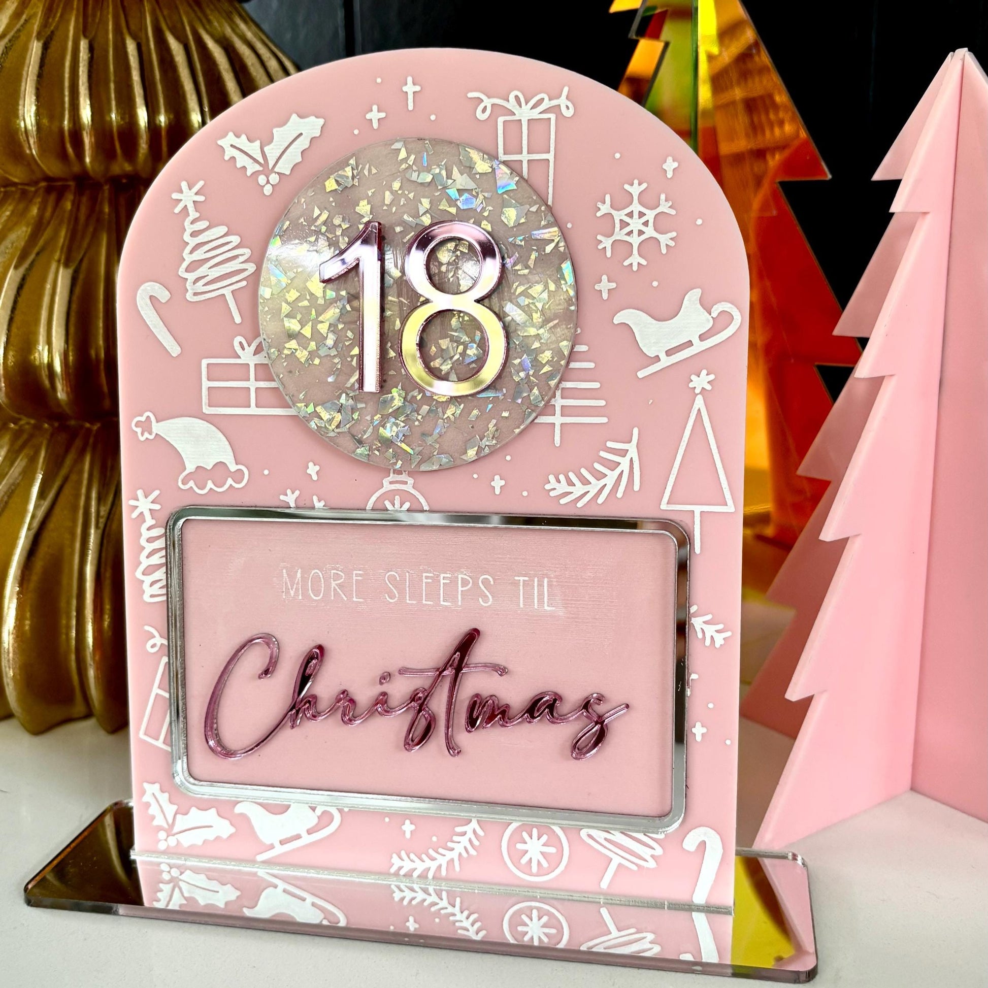Pink Christmas countdown timer with '18' and 'More sleeps til Christmas' text, surrounded by festive decorations.