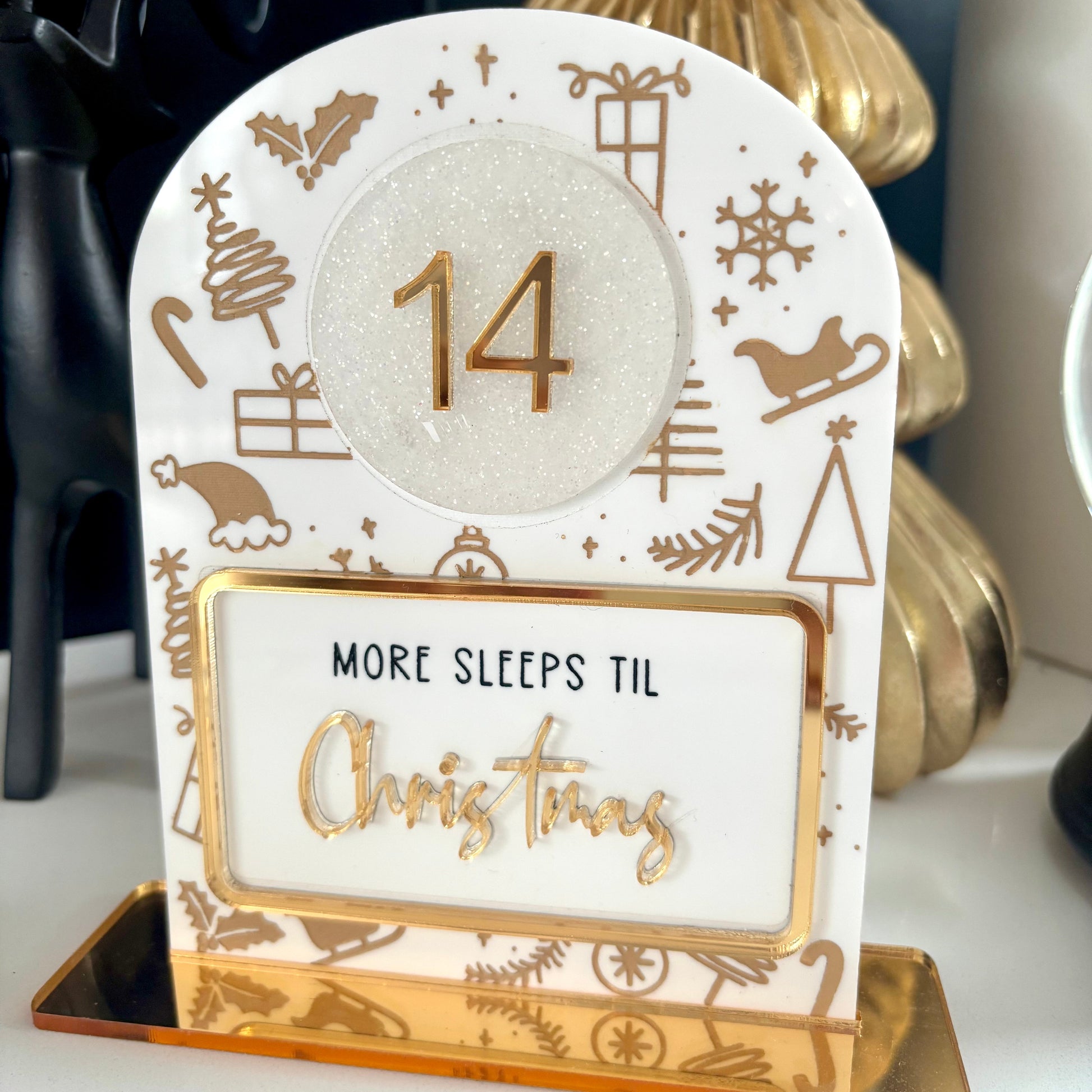 Christmas countdown card with number 14 and 'More sleeps til Christmas' text on a decorative stand.