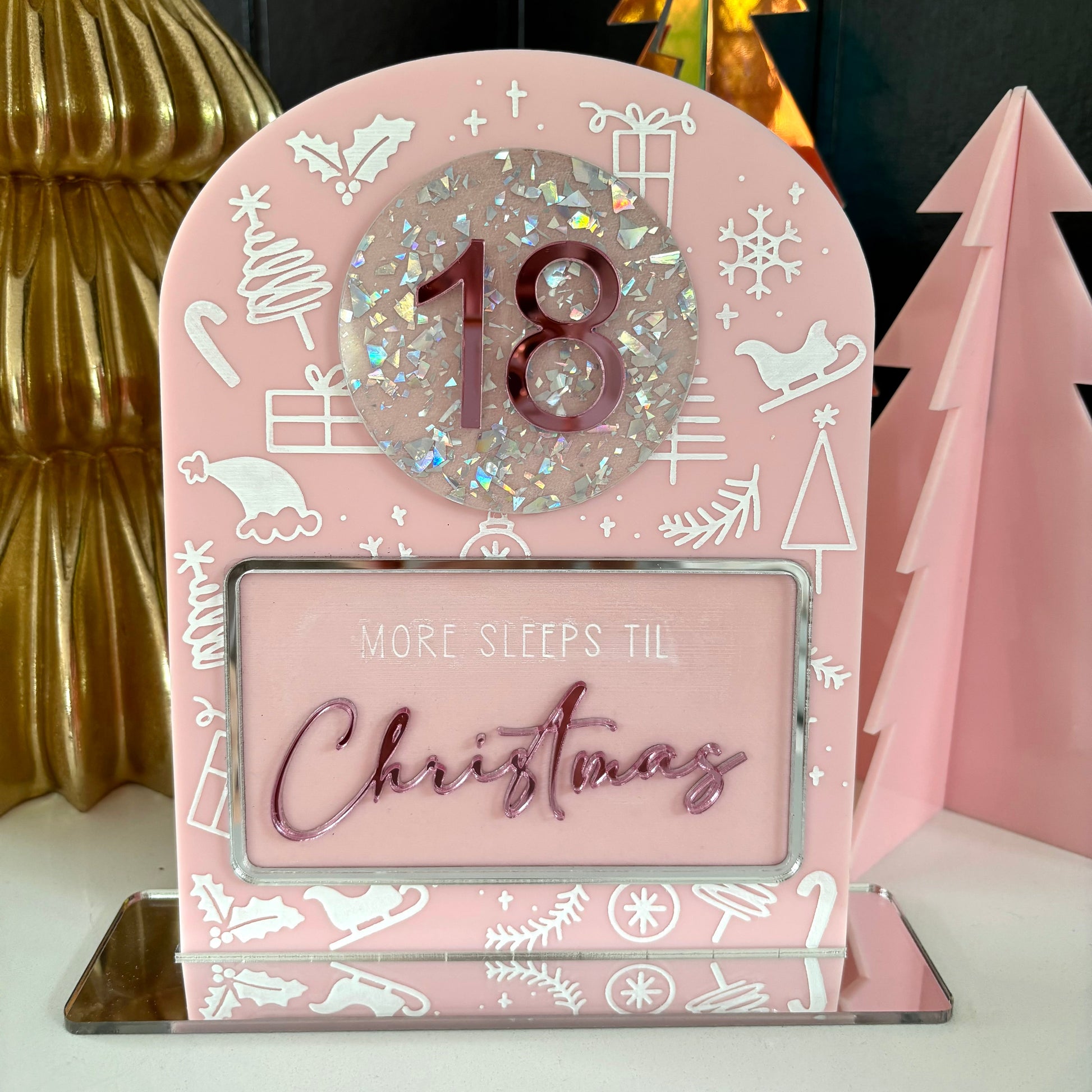 Pink Christmas countdown timer with '18' and 'More sleeps til Christmas' text, surrounded by festive decorations.
