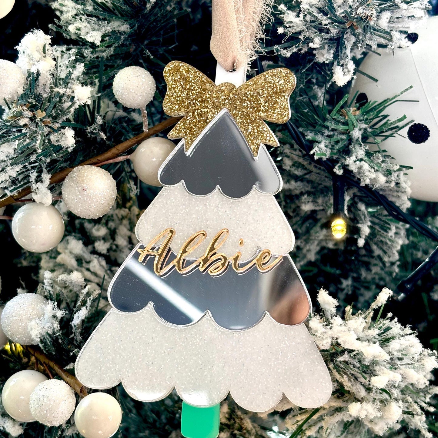 Decorative ornament with a name on a Christmas tree