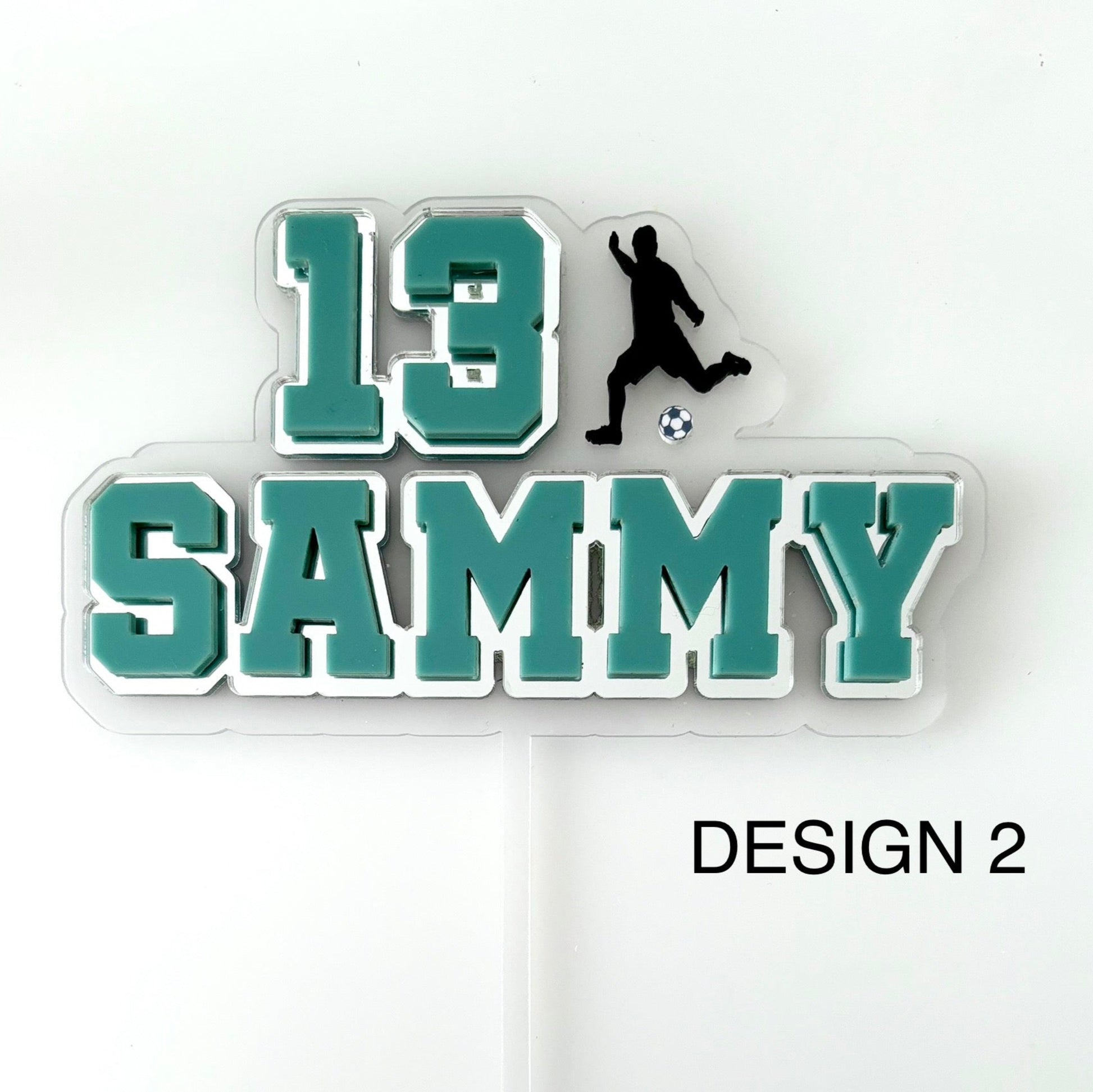Personalised soccer-themed name and number cake topper with a silhouette of a player and soccer ball on a clear background.