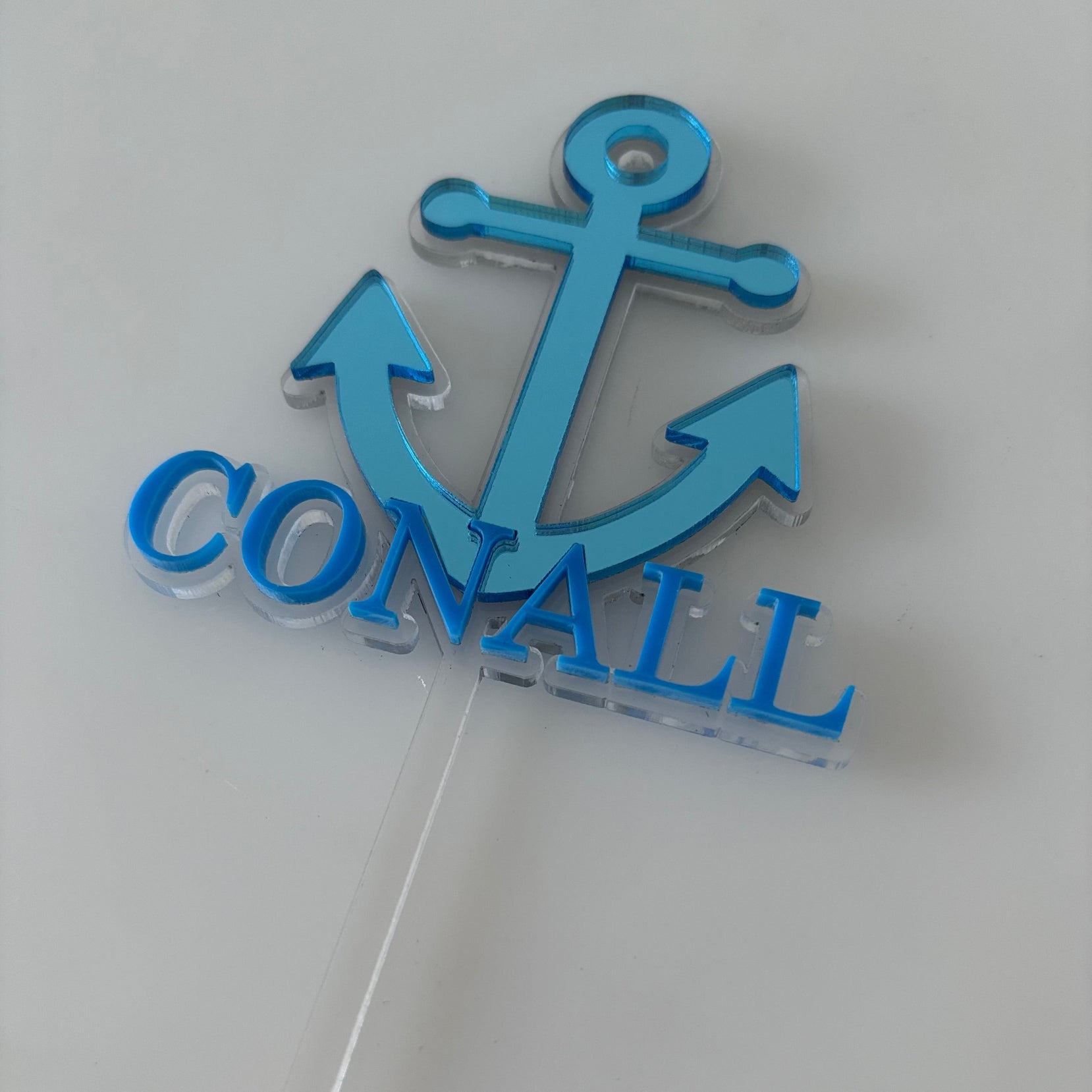 Personalised Blue anchor-shaped cake topper with mirrored acrylic.