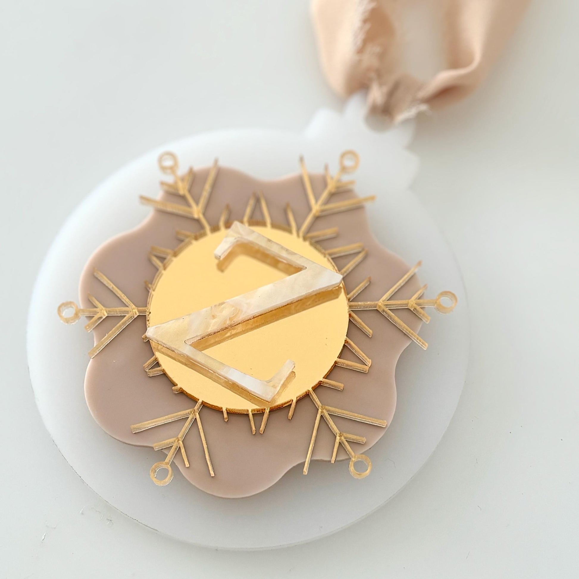 Christmas Bauble with a gold 'Z' on a white & beige background