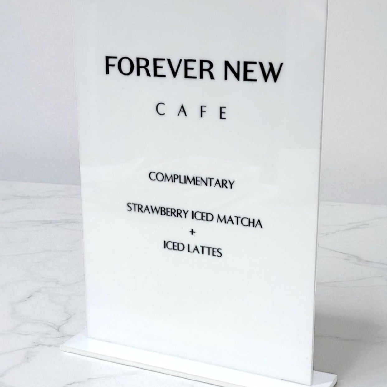 Menu for Forever New Cafe on a marble surface