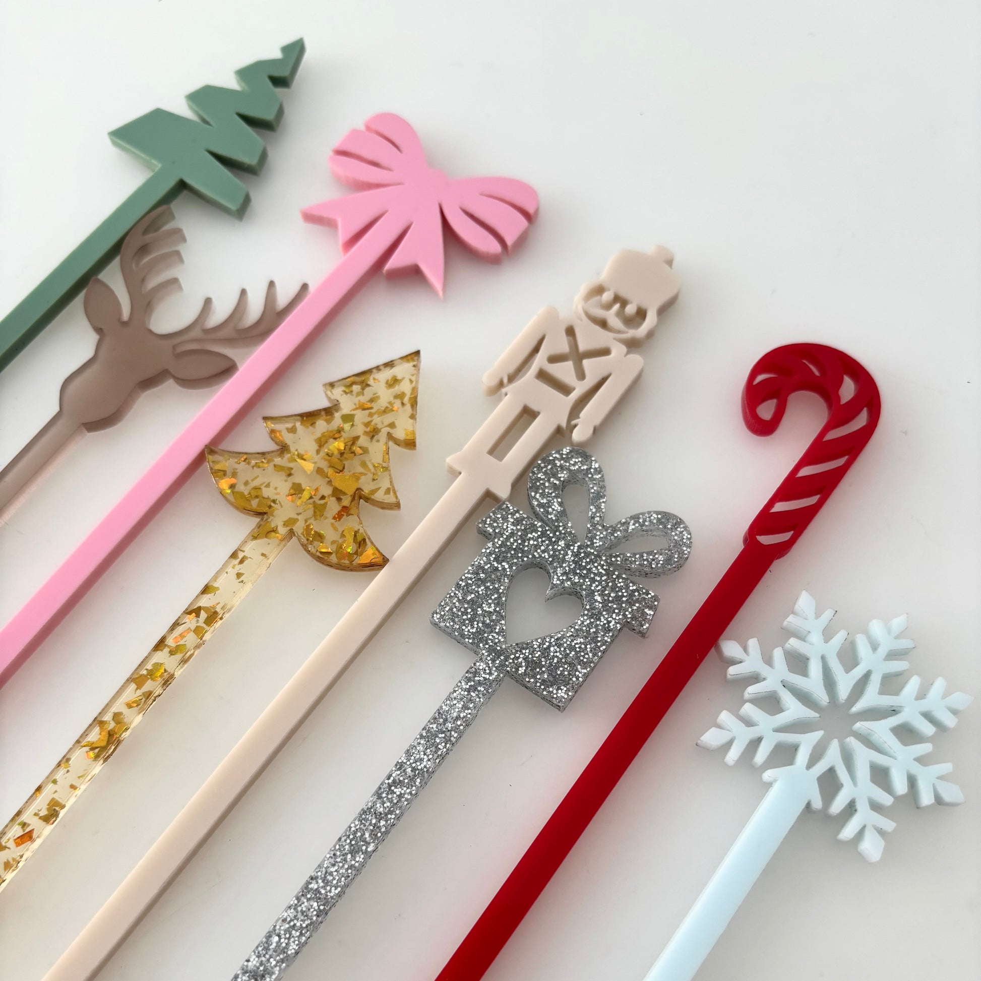 Set of decorative straws with various designs on a light background