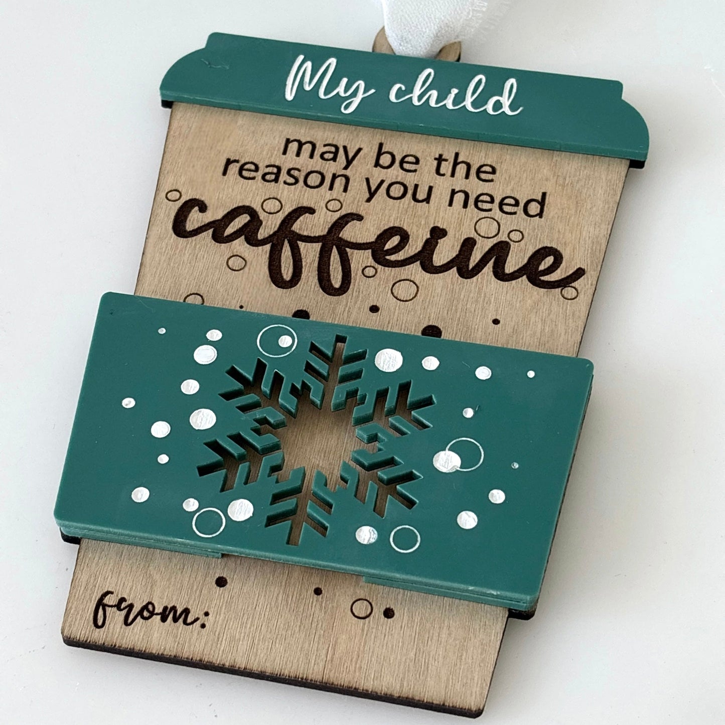 Decorative gift card holder with text 'My child may be the reason you need caffeine' on a white background
