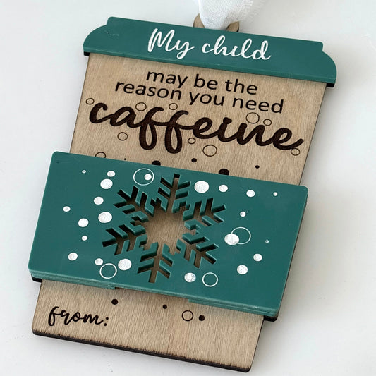 Decorative gift card holder with text 'My child may be the reason you need caffeine' on a white background