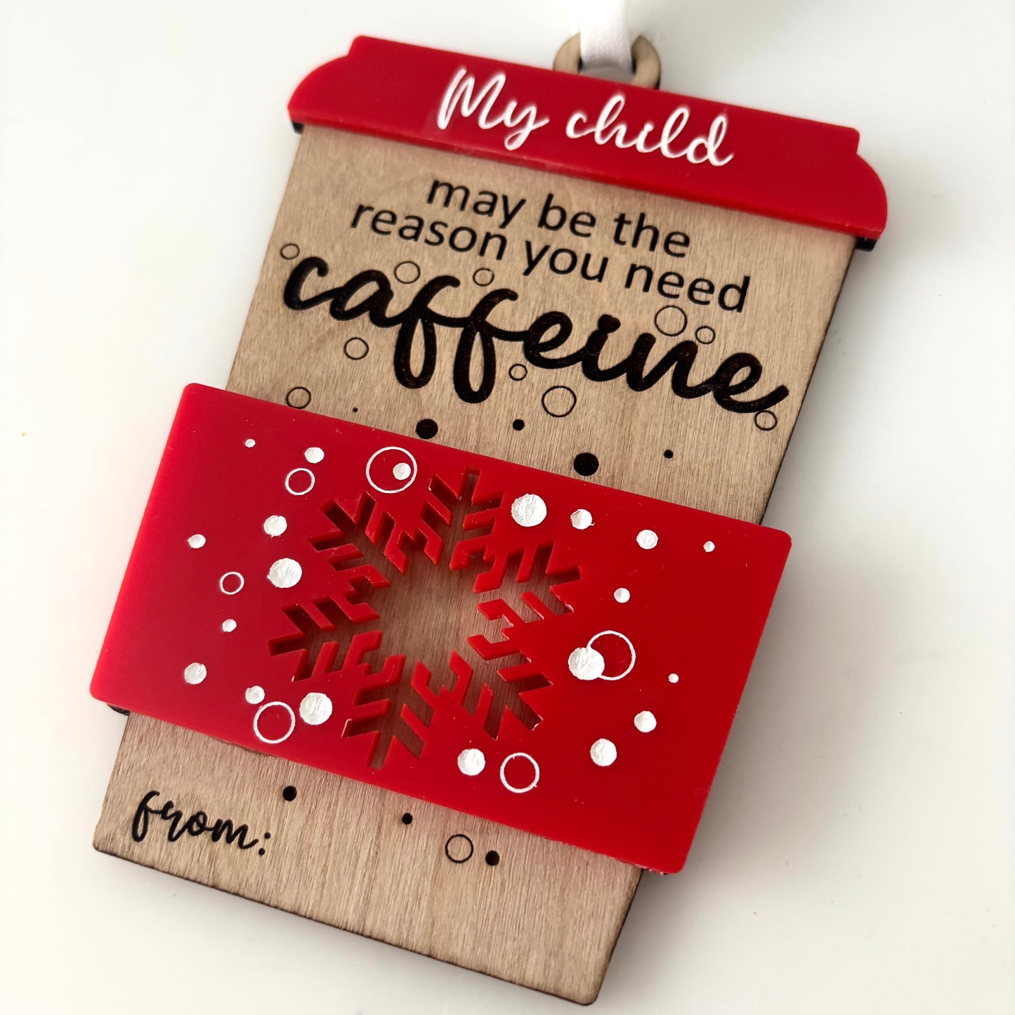 Decorative gift card holder with text and red snowflake design on a white background
