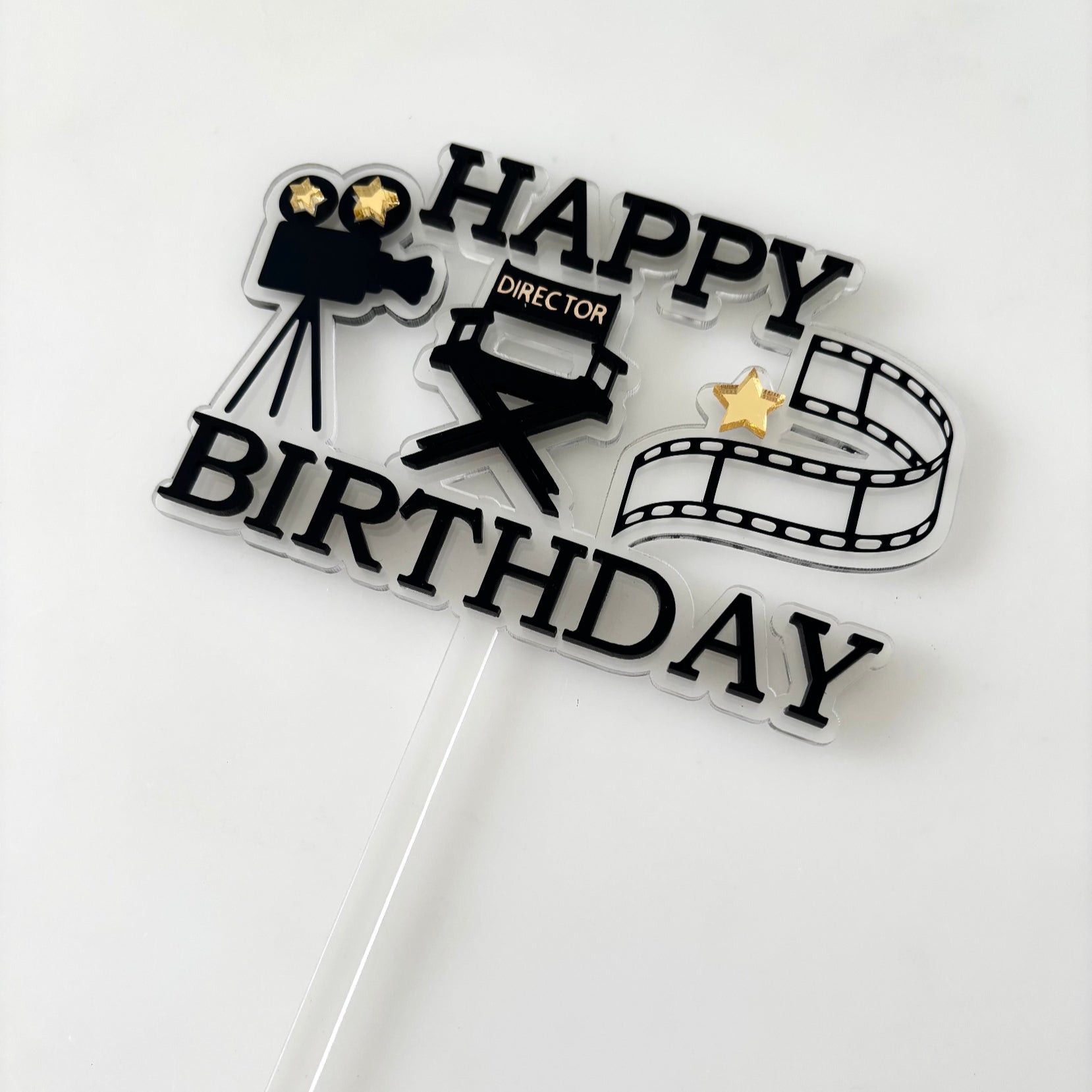 Cake topper with movie-themed design on a white background