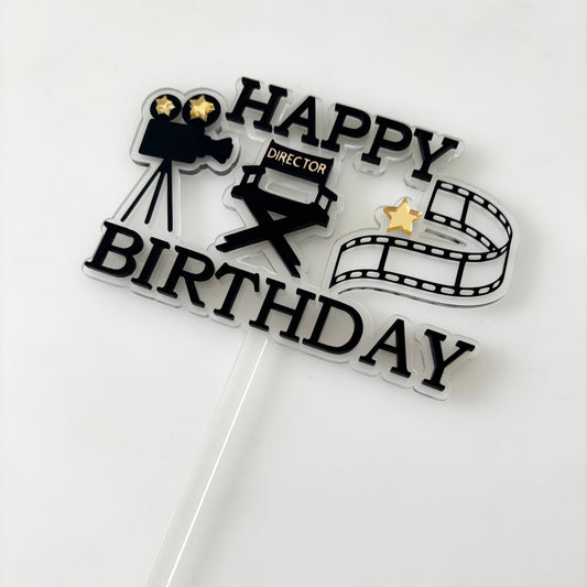 Cake topper with movie-themed design on a white background