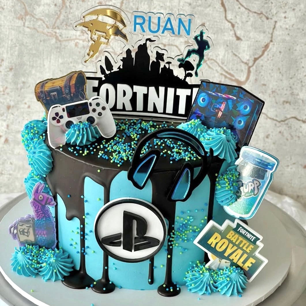 Decorative cake with gaming-themed elements on a marble surface