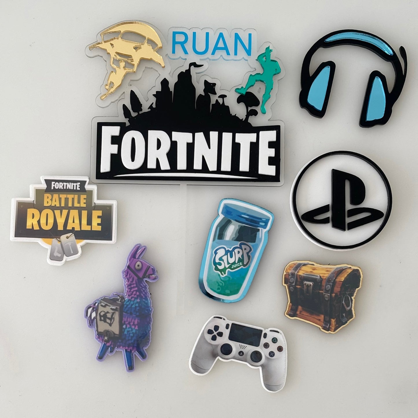 Collection of gaming-themed cake charms on a white background