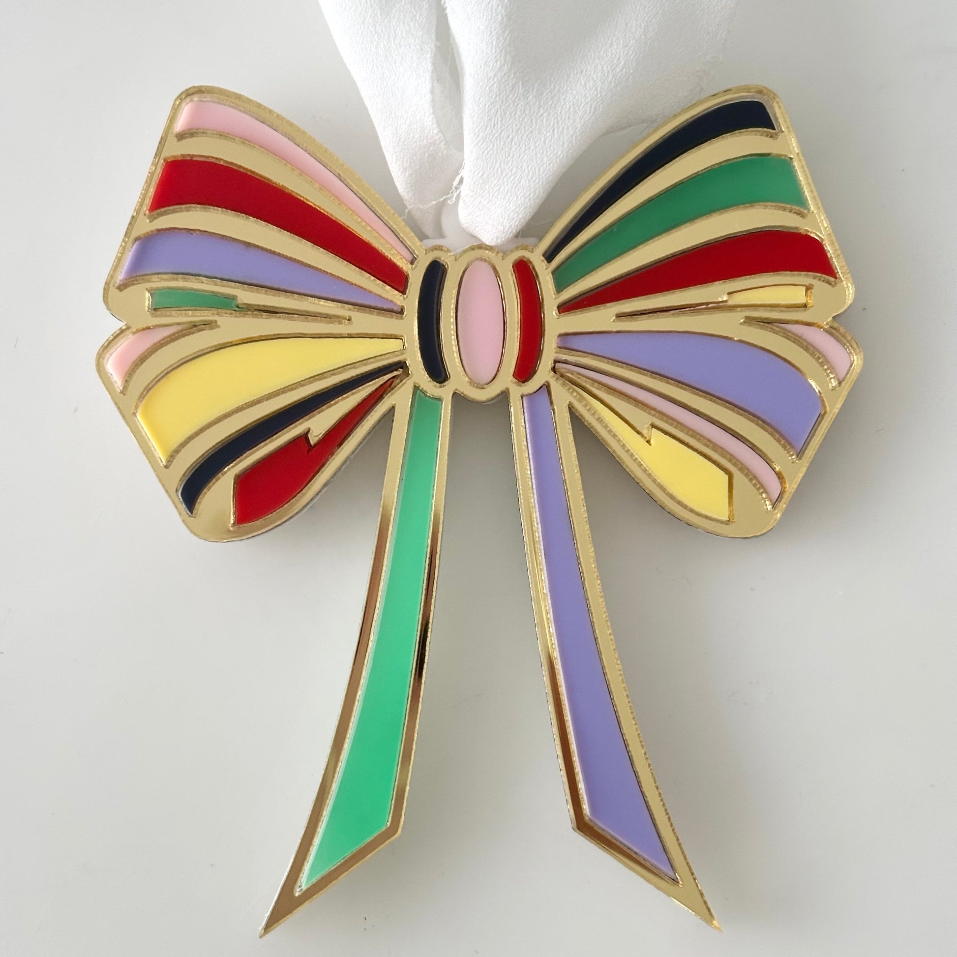Colorful bow-shaped Christmas ornament on a white background