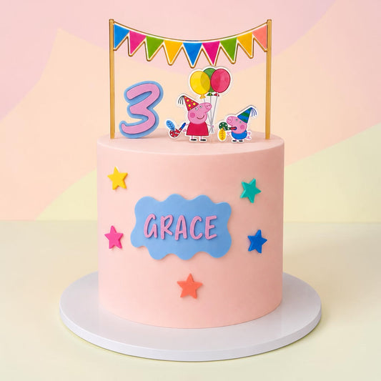 A pink frosted birthday cake on a white round base, decorated with a blue cloud-shaped nameplate reading 'GRACE', colorful stars, and a festive topper featuring a large number 3, Peppa Pig characters, and balloons under a bunting banner.