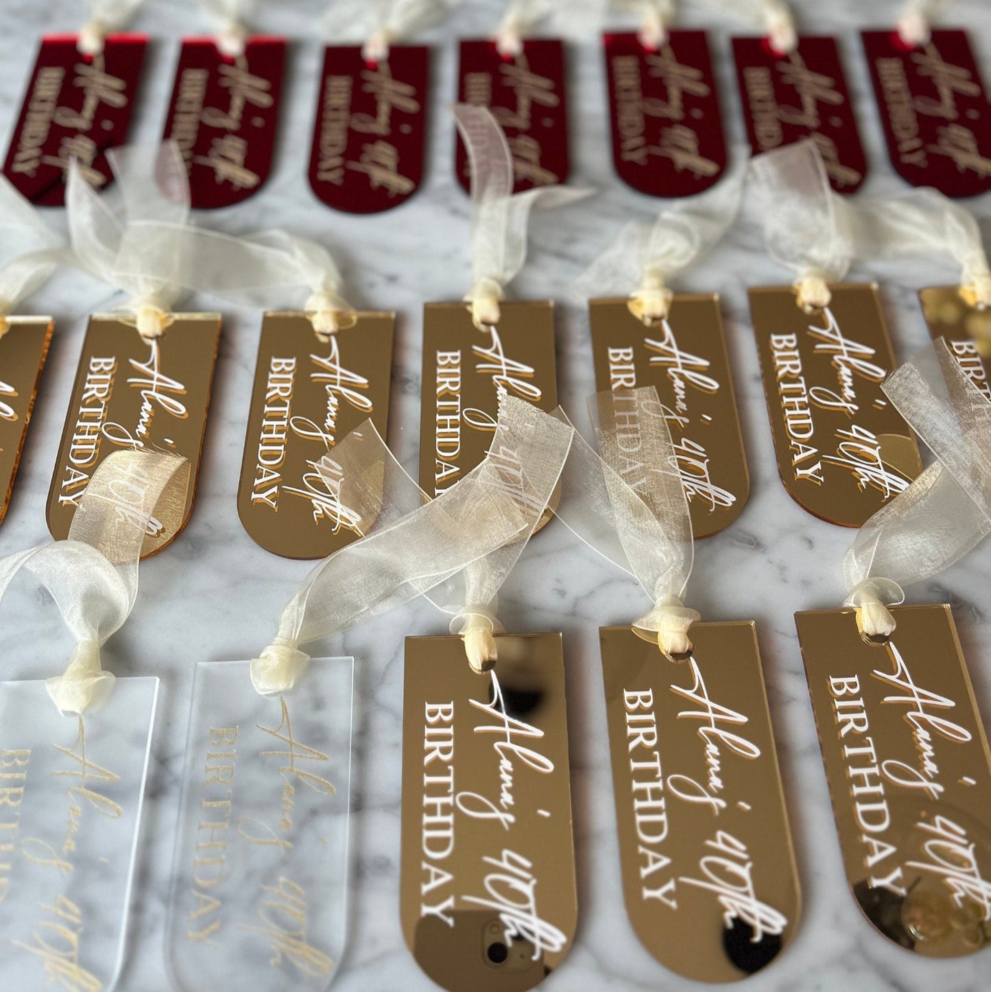 Row of gold tags with 'Happy Birthday' text on a white background
