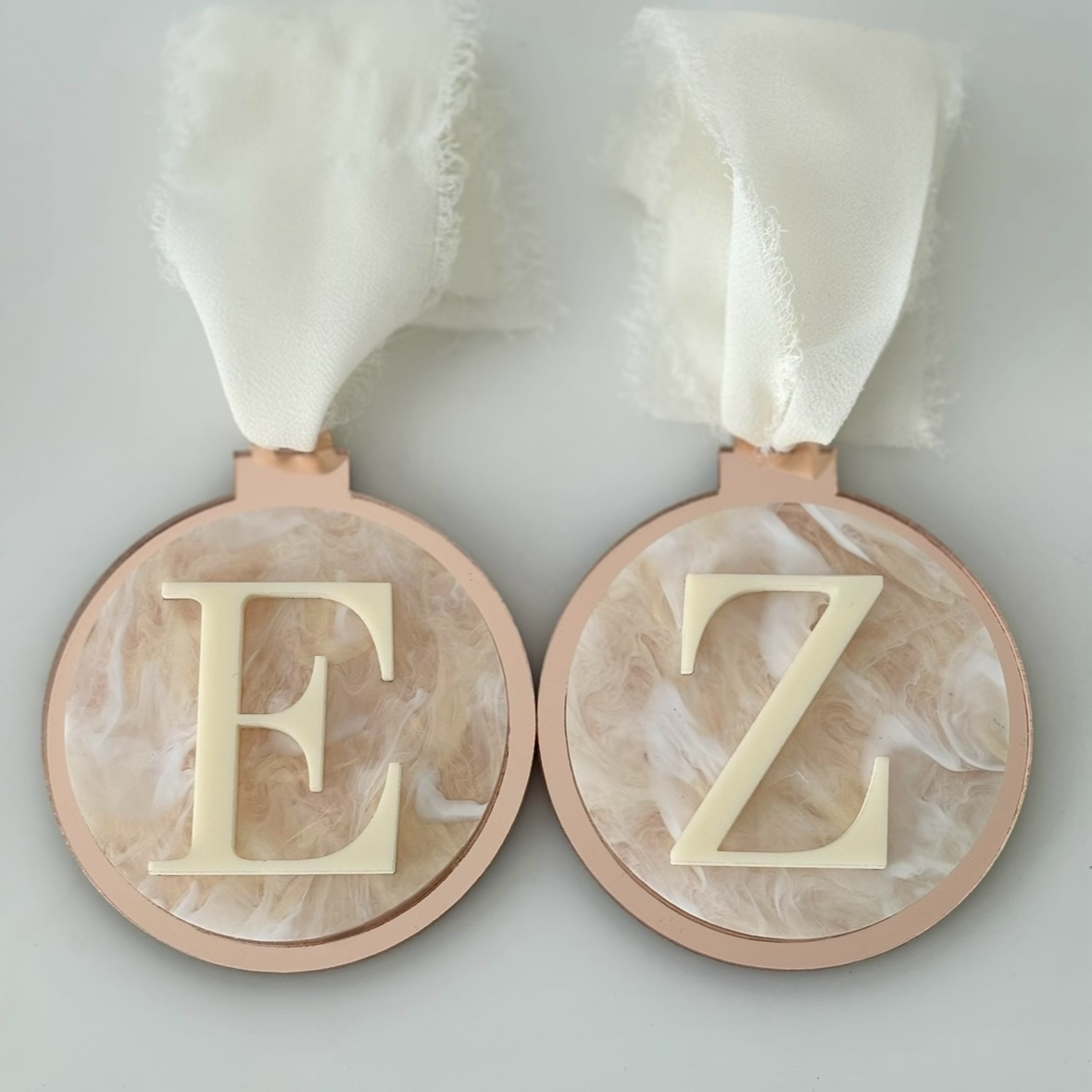 Two decorative christmas baubles with 'E' and 'Z' letters on a white background