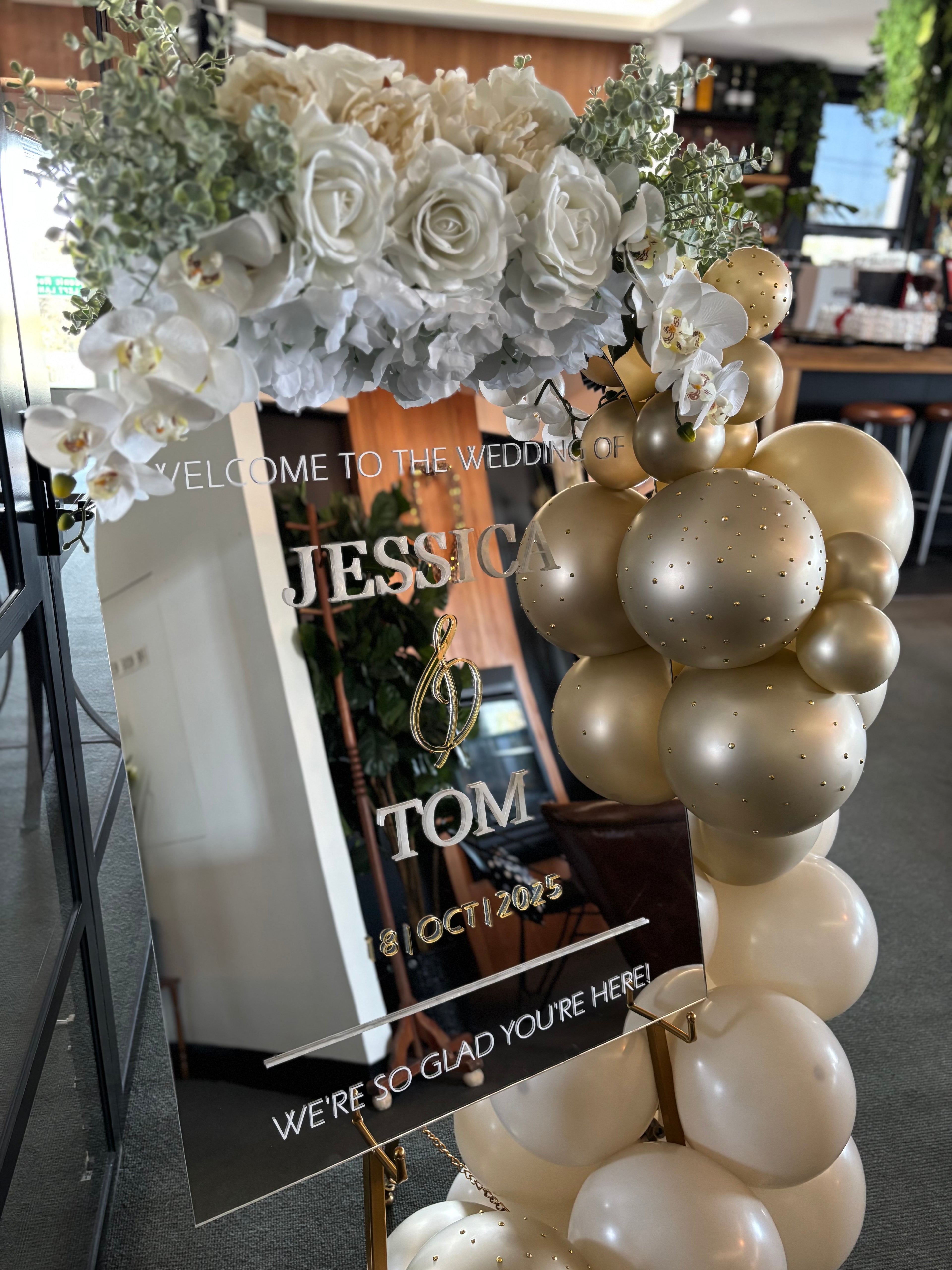 A1 Wedding Sign floral arch with balloons and a welcome sign for a wedding at a venue.