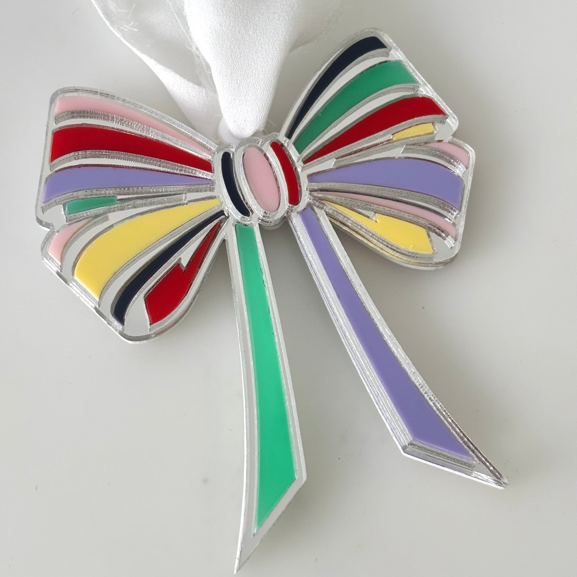Colorful bow-shaped Christmas Ornament on a white background
