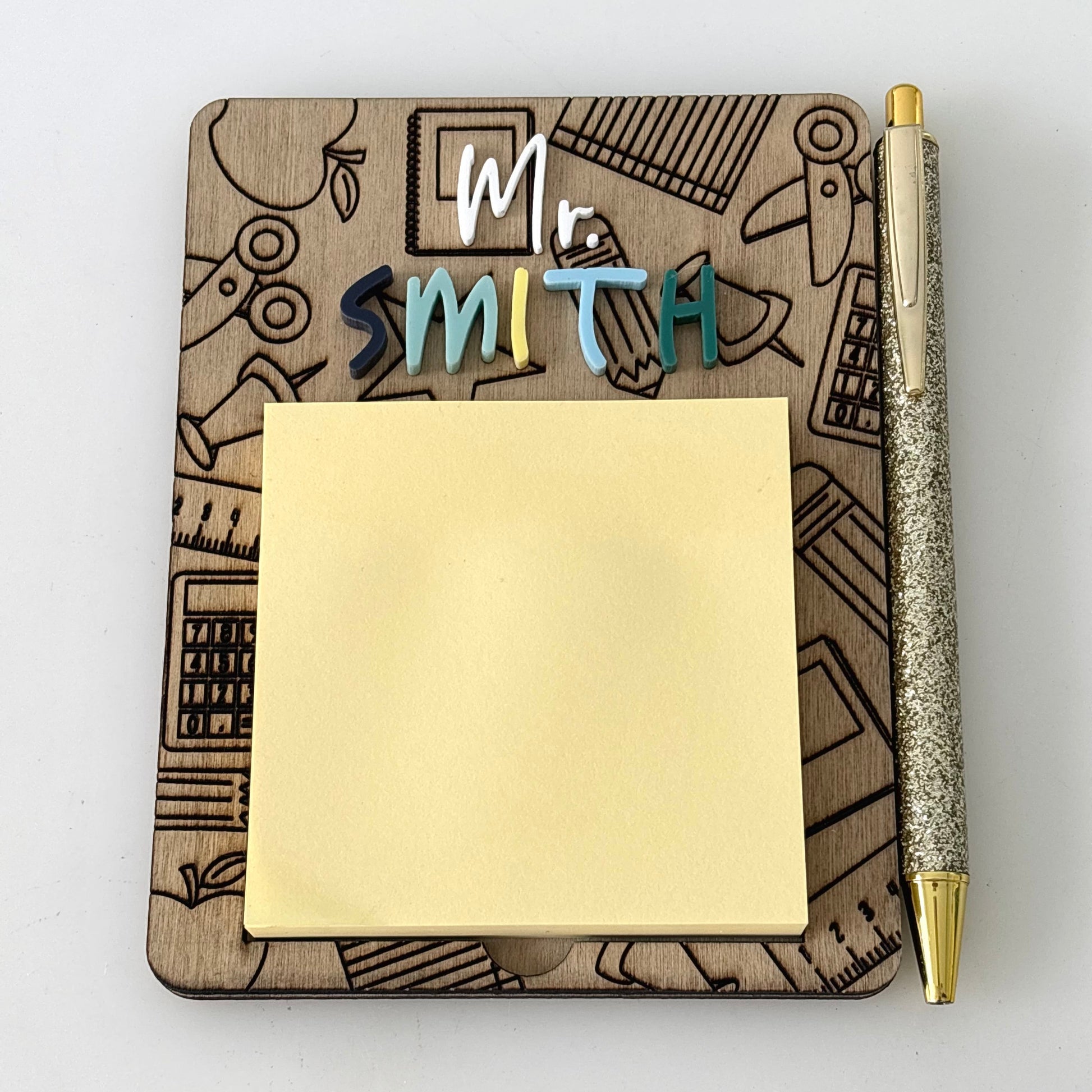 Notebook with 'Mr Smith' personalized name, sticky notes, and a pen on a white background