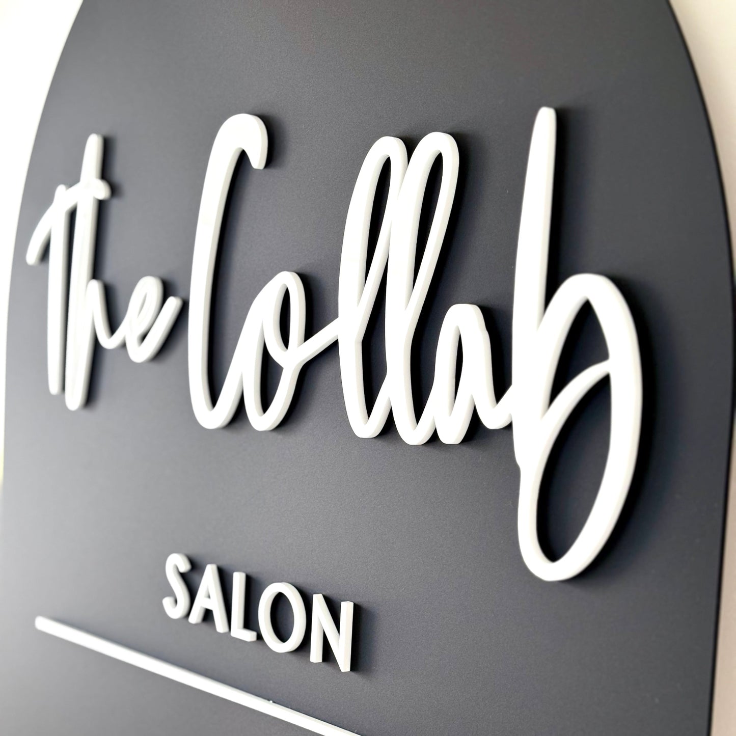 A1 Arch Business Signage black on a with white business logo in acrylic