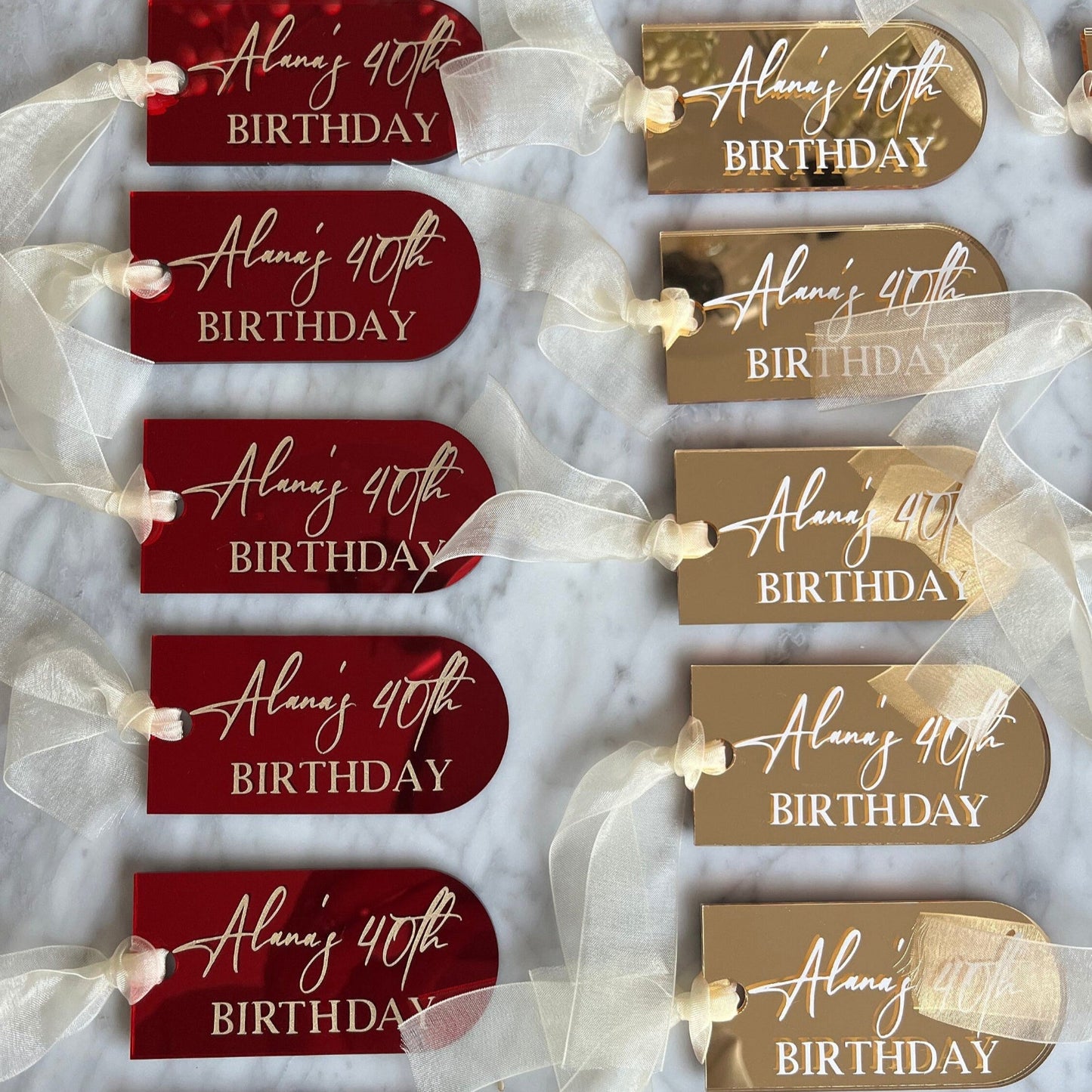 Set of personalized birthday gift tags with ribbons on a white background