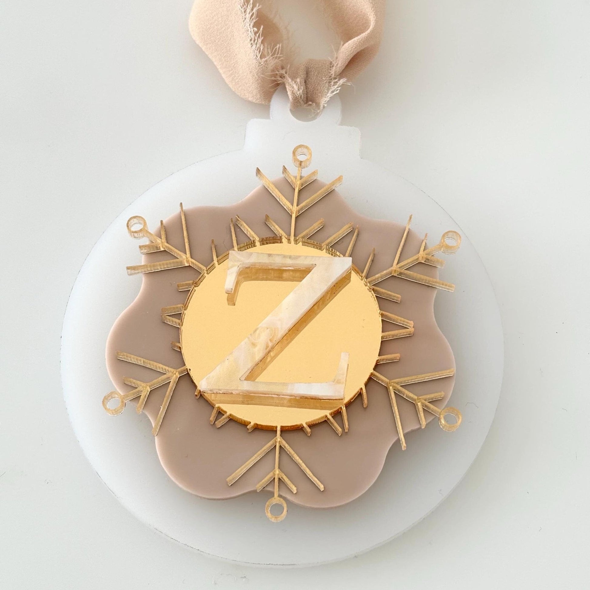 Christmas Bauble with a gold 'Z' on a white & beige background